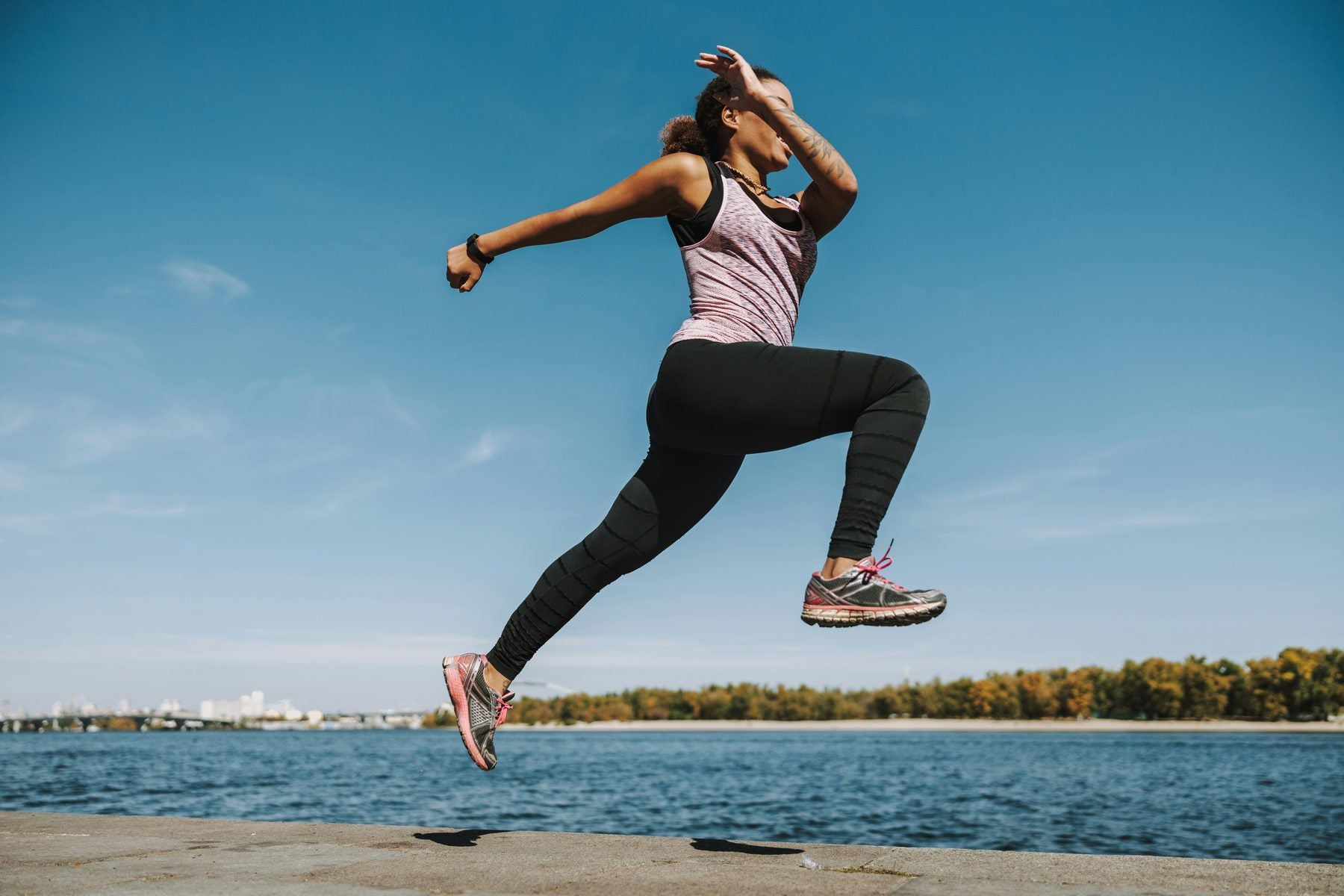 Woman jumping into a lake